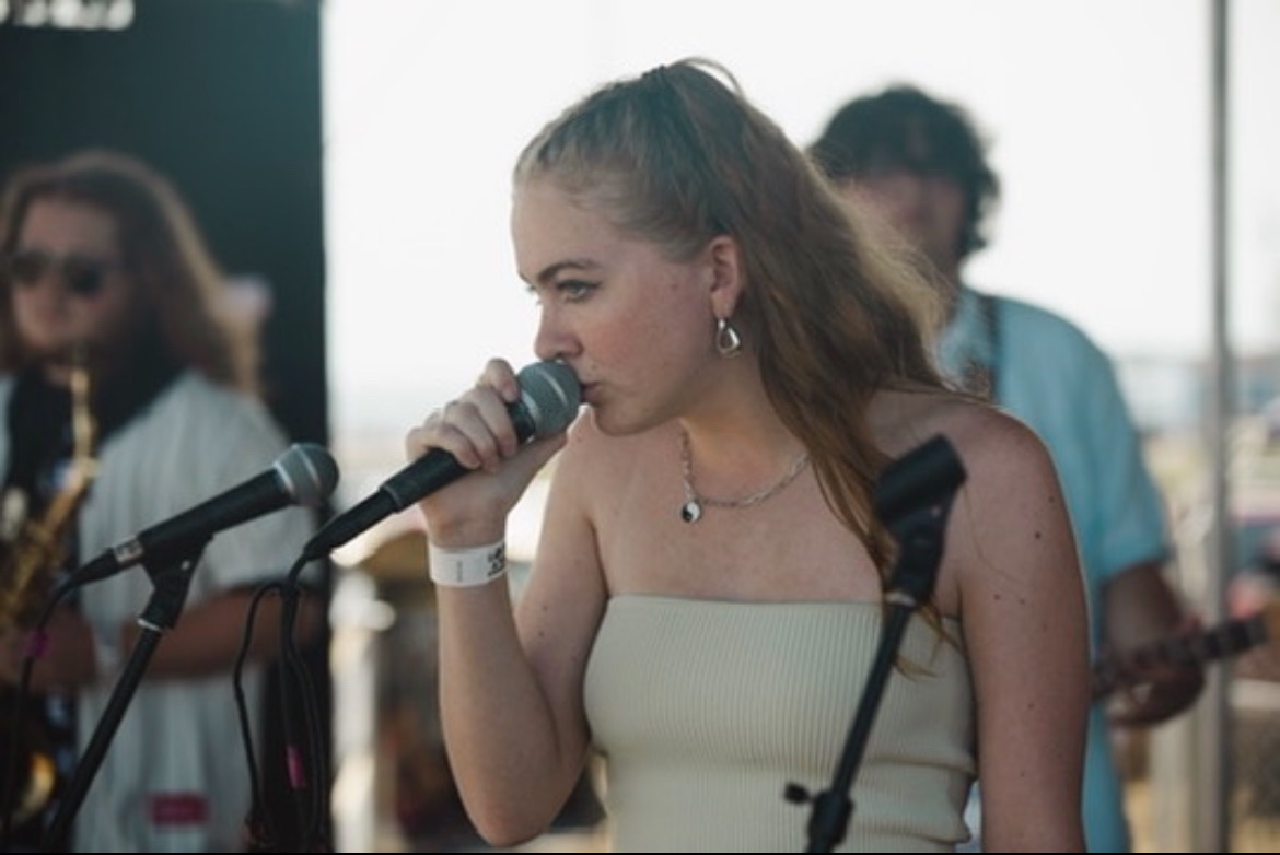 Sydneypacoustic singing into a microphone