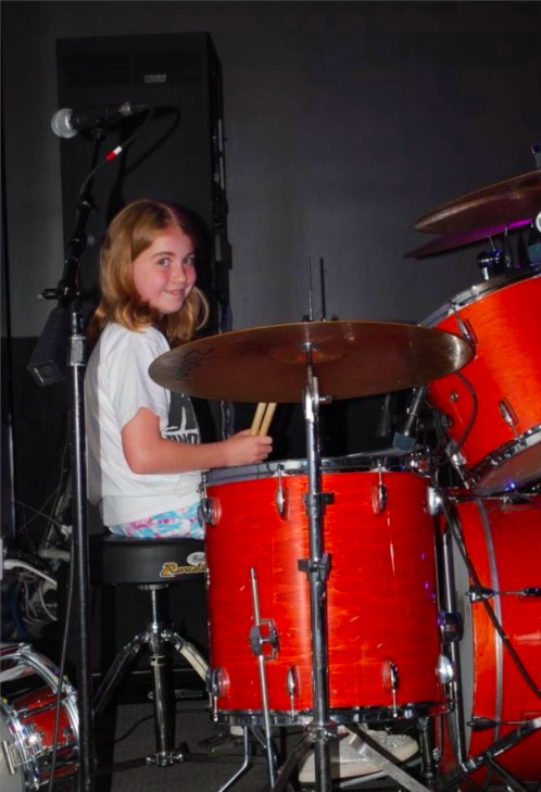 A young Sydneypacoustic playing the drums